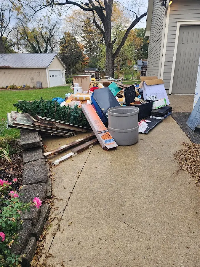 Dumpster being loaded with debris for 10 Yard Dumpster Rental in Lakeville